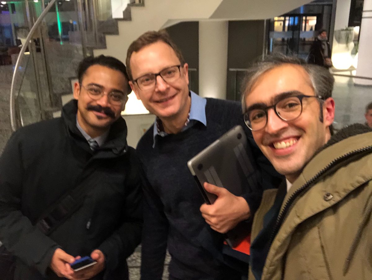 Three members of the founding team in a university foyer after the funding decision.