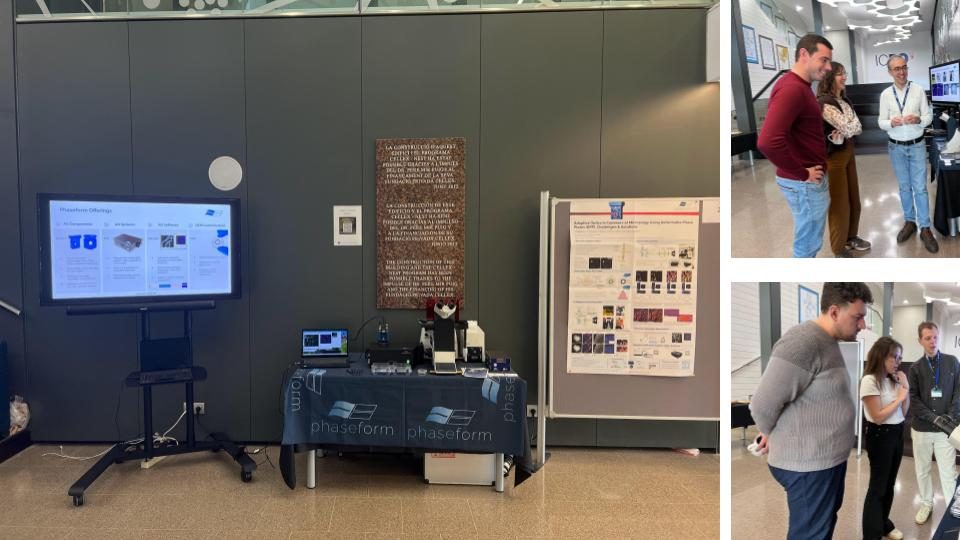The Phaseform exhibit in the ICFO foyer: a screen with the product overview, the demo table with a microscope and PHI under the Phaseform banner, a poster, and visitors in conversation at the stand.
